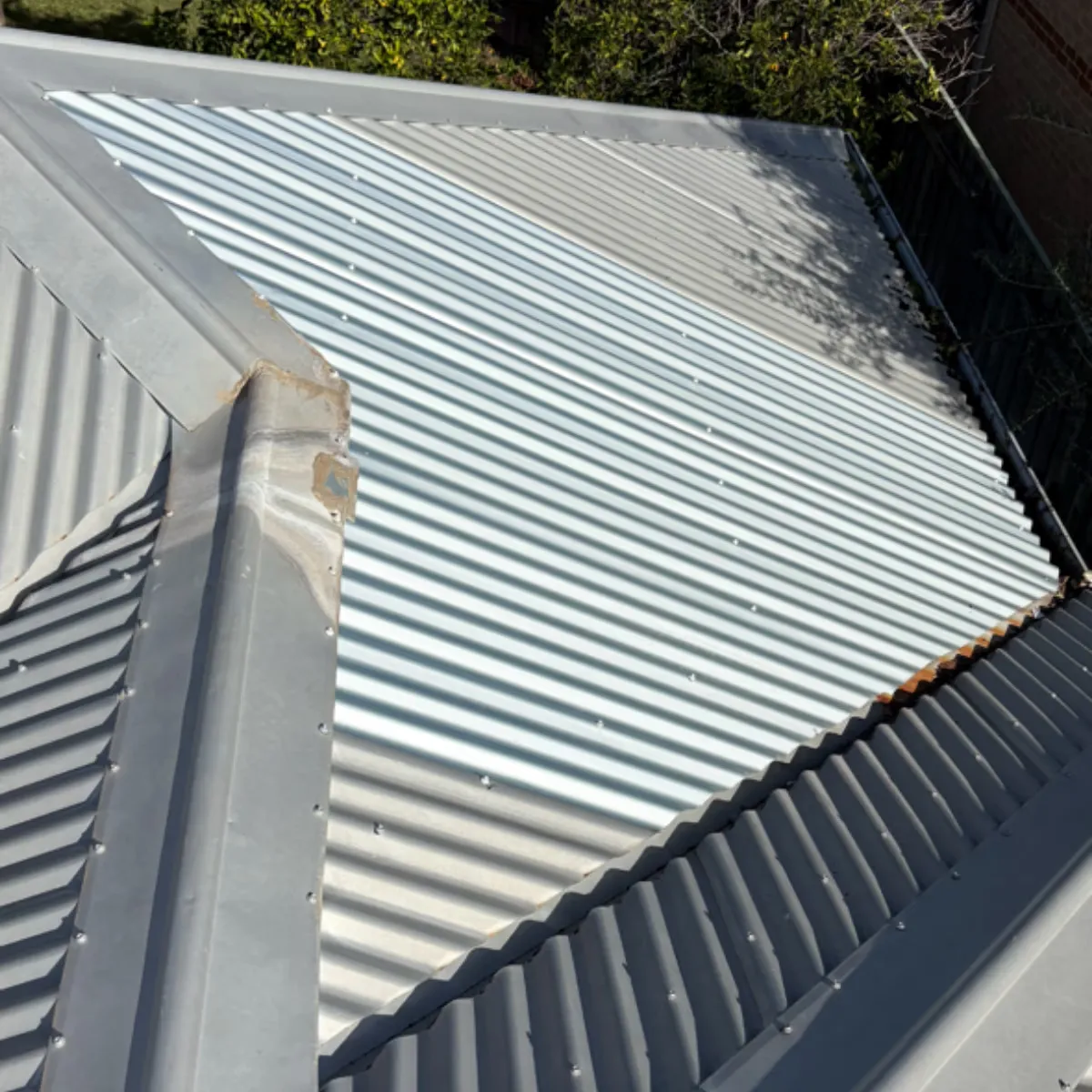 Repaired metal roof after removing an old evaporative cooler